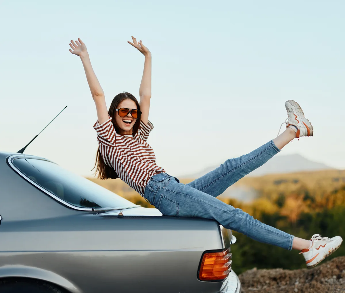 Person celebrating a new car with loans managed in the app