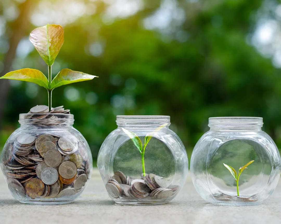 Savings growing from a jar of coins over time