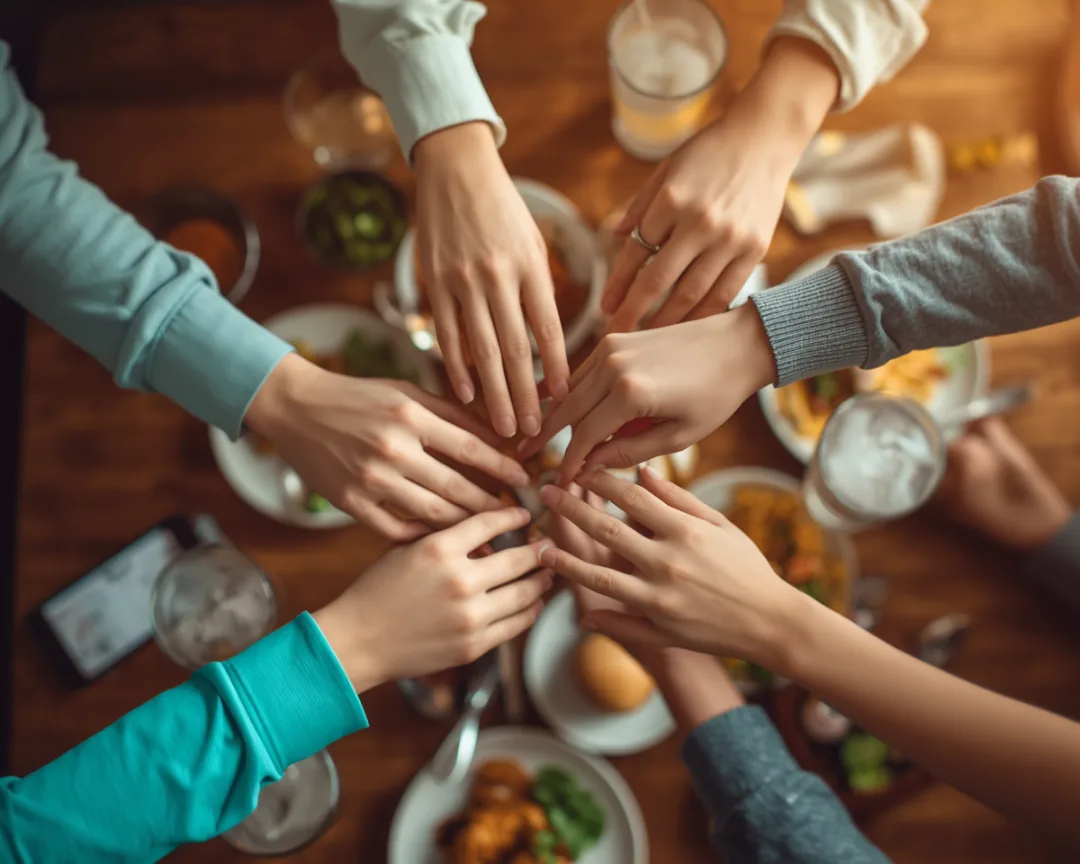 Friends dividing a shared bill five ways with the group expense tracker
